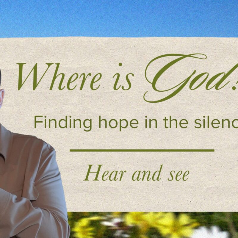 A photo of Pastor Josh Cooke, holding a microphone and speaking to the left of the frame. To the right is a beige, paper-like rectangle with a paperclip on the top right. Text on the rectangle reads, "Where is God? Finding hope in the silence. Hear and see." In the background is a field of yellow, white, and orange flowers under a blue sky.