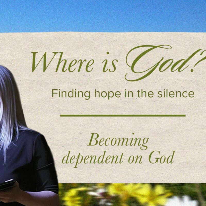A light-skinned woman with long, straight blonde hair and a black top holds a microphone to her mouth with her left hand and a tablet in her right. She stands in front of a blue sky and a field of yellow and orange flowers. To her right is a paper-like graphic with the words "Where is God? Finding hope in the silence" at the top, and "Becoming dependent on God" at the bottom. A paperclip is visible in the top right corner of the graphic.