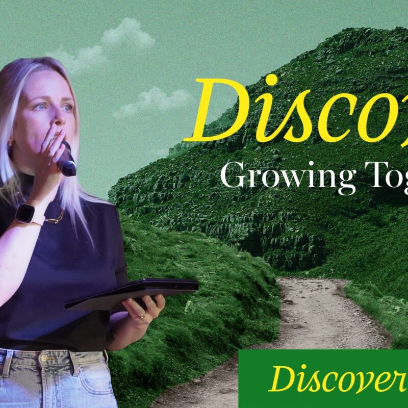 A blonde woman with a microphone stands in front of a green, mountainous landscape with a path winding through it. The words "Discover," "Growing Together," and "Discover Change" are superimposed on the image in yellow and green text.